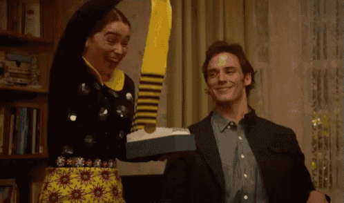 a man and woman are standing next to each other in a living room .