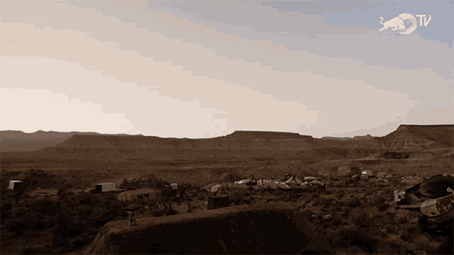 a picture of a desert landscape with a bull tv logo in the corner
