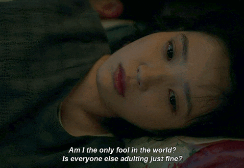 a woman laying on a bed with a caption that says am i the only fool in the world is everyone else adulting just fine