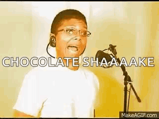 a young boy singing into a microphone with the words chocolate shaaaake written above him