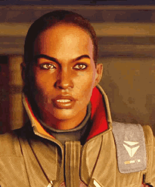 a close up of a woman 's face with a triangle patch on her jacket