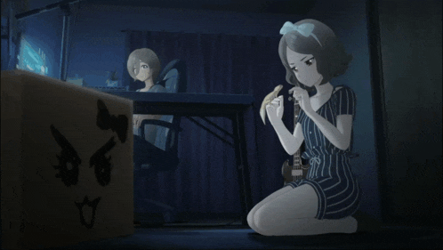 a girl is kneeling down in front of a cardboard box with a cat on it