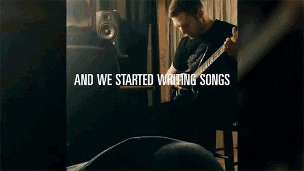 a man is playing a guitar with the words and we started writing songs below him