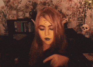 a woman with yellow paint on her face and the words just vibing above her