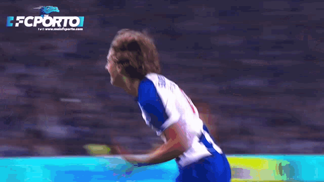 a soccer player in a blue and white uniform with the number 10 on his back
