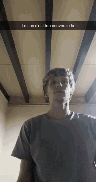 a man standing in front of a ceiling with the caption le sac c'est ton couvercle la