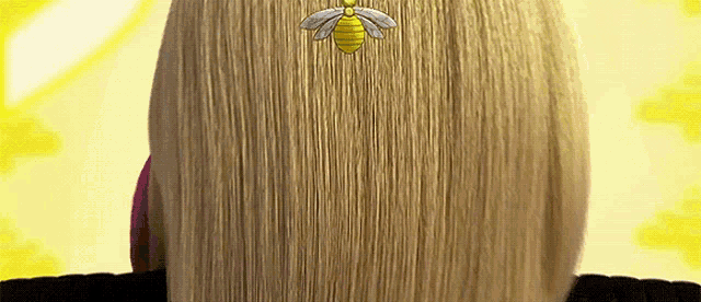 a woman 's hair has a bee embroidered on it