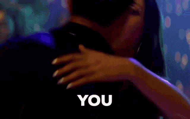 a man and a woman are dancing and the woman is saying " you "