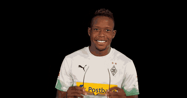 a man wearing sunglasses and a shirt that says postbank on it