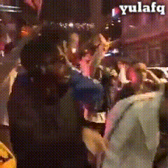 a blurred image of a crowd of people with the word yulefq on the bottom right