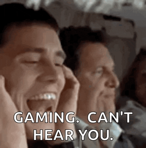 a man covering his ears while another man says gaming can 't hear you .