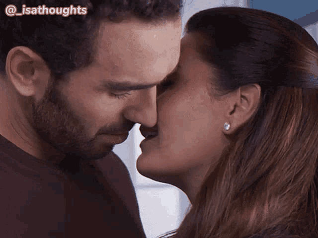 a close up of a man and woman kissing with the words @isathoughts above them