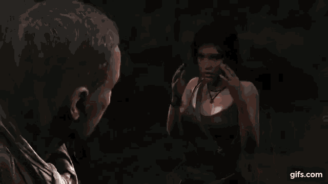 a man and a woman are holding hands in a dark room .