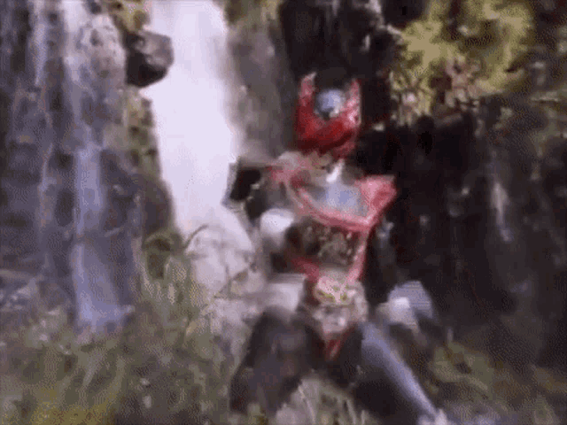 a superhero is standing in front of a waterfall in the jungle .