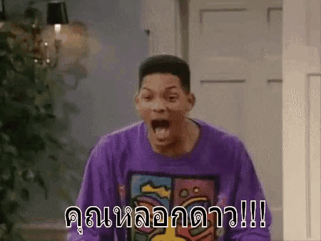 a man in a purple shirt is making a funny face with his mouth wide open .