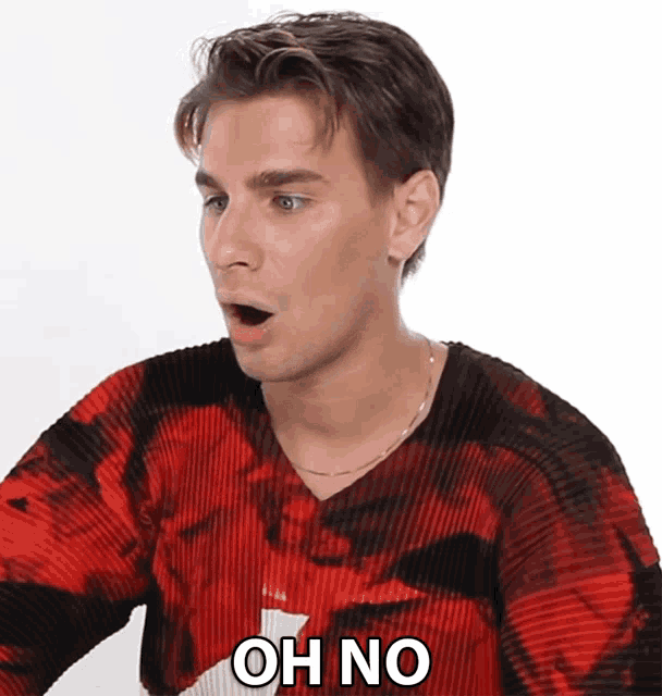 a man in a red and black sweater says " oh no "