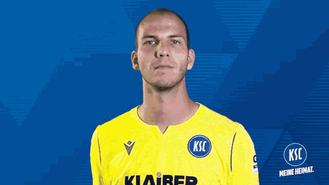 a man wearing a yellow shirt with ksc written on it
