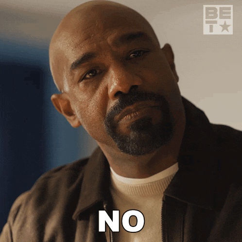 a bald man with a beard is making a no sign
