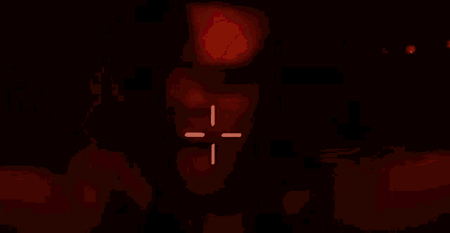 a man in a red room with a cross on his face .