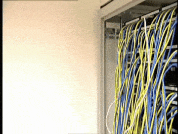 a bunch of wires are hanging from a rack with one that says ' eee ' on it