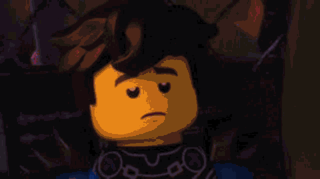a close up of a lego figure with a sad look on his face .