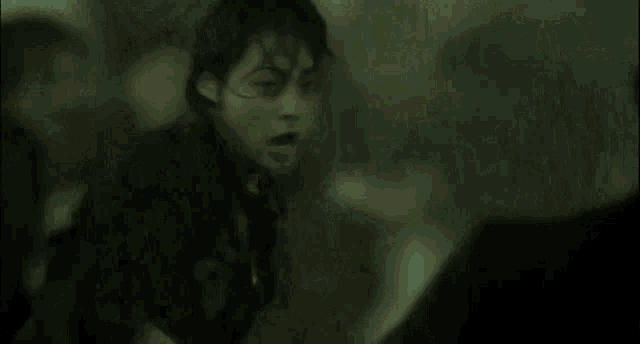 a blurry picture of a person 's face and a green background .