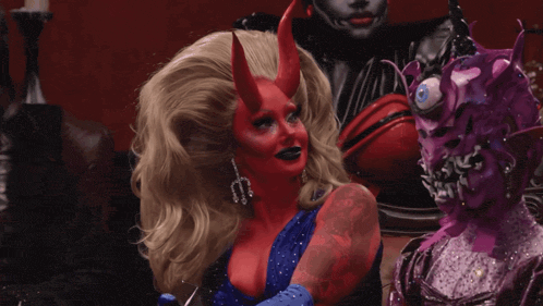 a woman in a devil costume with horns and earrings