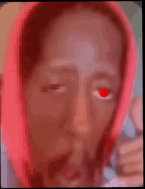 a blurry picture of a woman with red eyes