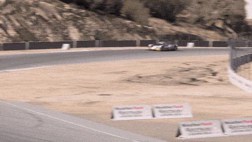 a race car is going down a track with a sign that says weathertech