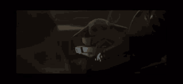 a close up of a person wearing a helmet in the dark .