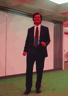 a man in a suit and tie is dancing in an office