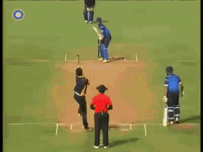 a cricket game is being played on a field with a referee in the middle .