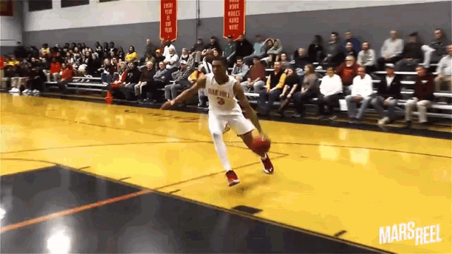 a basketball player with the number 3 on his jersey is dribbling the ball on a court