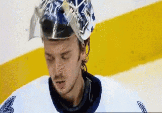 a hockey player is wearing a helmet with the letter a on it