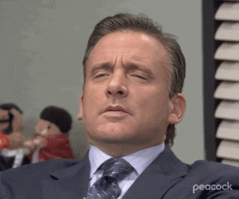a man in a suit and tie is making a face .