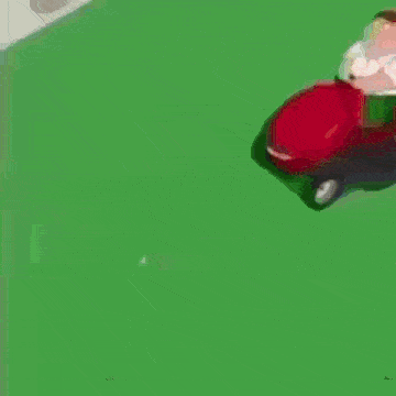 a cartoon character is riding a lawn mower on a lush green field