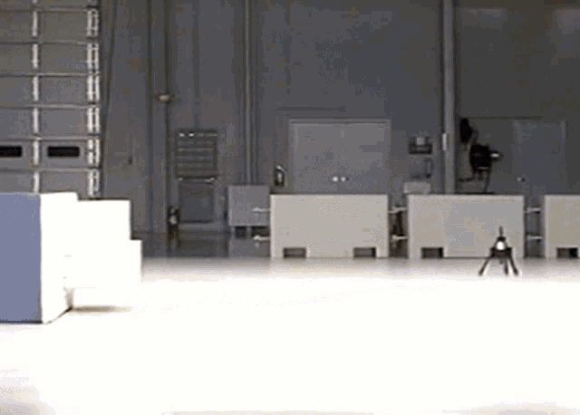 a warehouse with a lot of white boxes and a ladder in the background