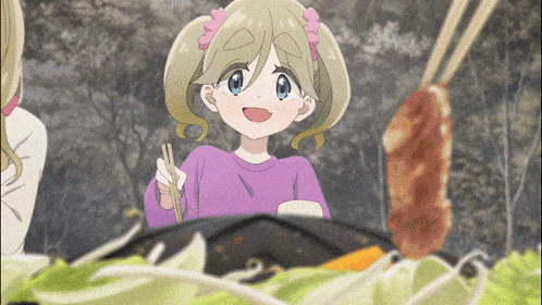a girl in a purple sweater is holding chopsticks in front of a plate of food