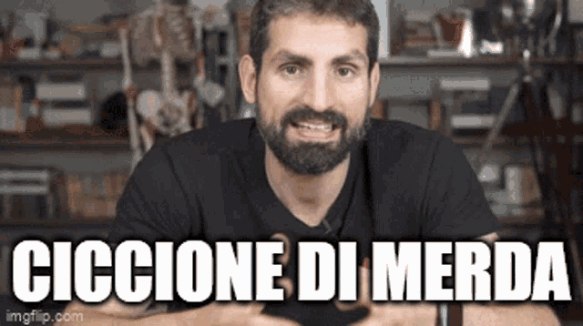 a man with a beard is sitting in front of a skeleton and a sign that says ciccione di merda .