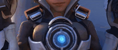 a close up of a person holding a device with a blue light on it .