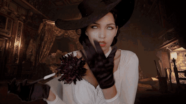 a woman wearing a hat and gloves holds a flower
