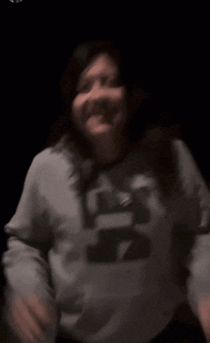 a blurry picture of a girl wearing a hoodie with the letter a on it