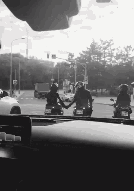 a couple holding hands while riding motorcycles with a license plate that says nct - 88