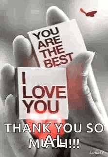 a person is holding two cards in their hand that say `` you are the best i love you '' .