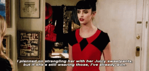a woman in a red dress is talking to another woman while wearing sweatpants .