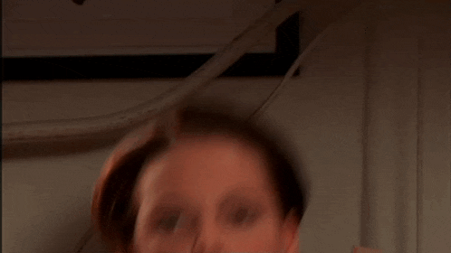a close up of a woman 's face with her mouth open
