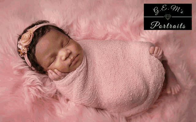 a baby is wrapped in a pink blanket with g.e.m. 's portraits written in the corner