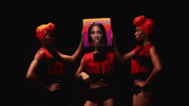 a woman holding up a picture of a woman with the name tima savage on it