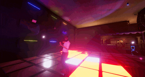 a man in a white shirt is standing on a dance floor in a club
