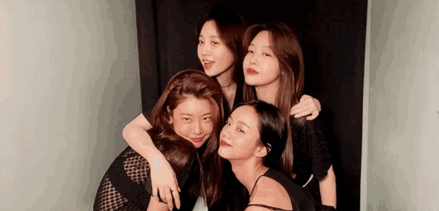 a group of young women posing for a picture in a photo booth .